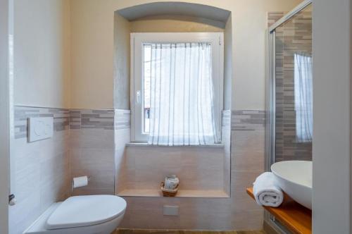 a bathroom with a toilet and a sink at Comfy & Roomy Apt - View on the Ligurian Hills! in Vezzano Ligure