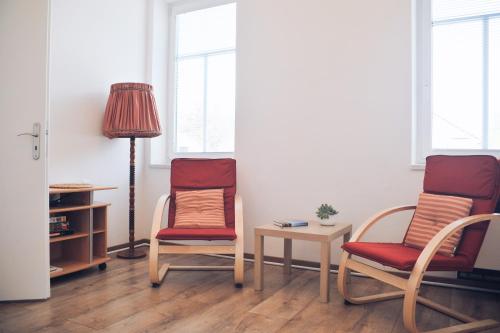 a room with two chairs and a table and a lamp at Apartmán Rybná - Kraslice in Kraslice