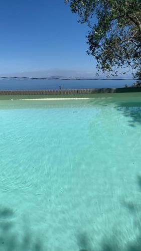 a large body of water with a beach in the background at Antonio Massa Lubrense in Massa Lubrense