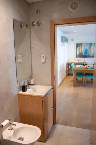 a bathroom with a sink and a mirror at 1 Bed Boutique-style Apartment in São Martinho do Porto