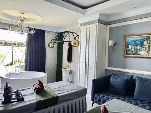 a living room with a couch and a sink at Grand Eska Hotel & Suites Batam in Nagoya