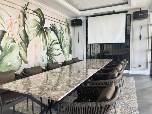 a conference room with a large table and chairs at Grand Eska Hotel & Suites Batam in Nagoya