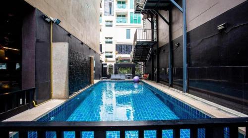 a swimming pool with a purple ball in a building at GranDE Classic Pattaya in North Pattaya