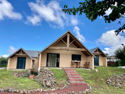 a house with a pitched roof at Le Chalet du Renard in Le Tampon