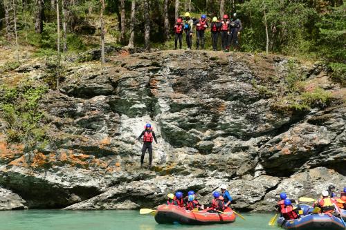 a group of people on rafts in a river at HI Sjoa in Otta