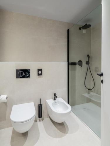 a bathroom with a toilet and a sink and a shower at Hotel Villa Rosetta in Savudrija