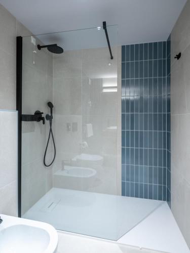 a bathroom with two sinks and a shower at Hotel Villa Rosetta in Savudrija