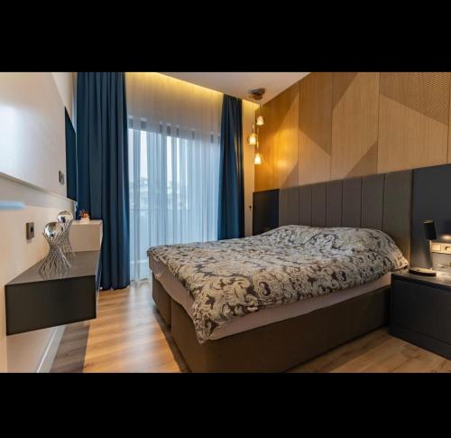 a bedroom with a bed and a large window at Lux Apartment C-LOUNGE CLEOPATRA, Cleopatra beach Alanya in Alanya