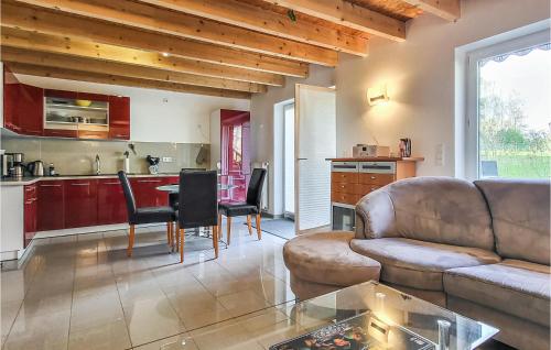 a living room with a couch and a table at Awesome Home In Wittstock With Kitchen in Wittstock