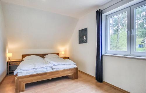 a bedroom with a bed and a large window at Awesome Home In Wittstock With Kitchen in Wittstock