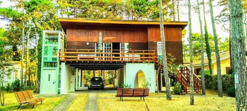 a small house with a balcony on top of it at ARThouse ANNA Villa in Lignano Sabbiadoro