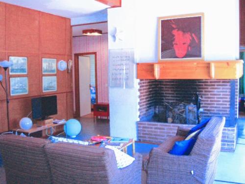 a living room with two couches and a fireplace at ARThouse ANNA Villa in Lignano Sabbiadoro
