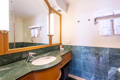 y baño con lavabo y espejo. en Luxury Ocean View Studio Apartments en Gold Coast