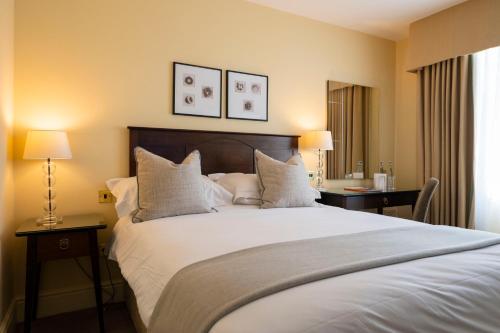 a bedroom with a large bed with white sheets and pillows at St George's Hotel - Llandudno in Llandudno