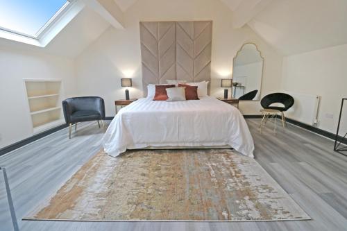 a bedroom with a large bed and a large rug at Black Pearl Stays - Saltburn Apartments in Saltburn-by-the-Sea