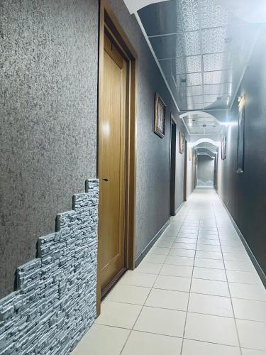 a corridor in a building with a door and stairs at Kharkovlux in Kharkiv