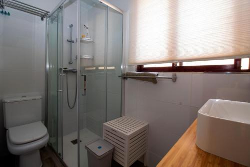 a bathroom with a shower and a toilet and a sink at Yate 4, primera linea de playa. in Fuengirola