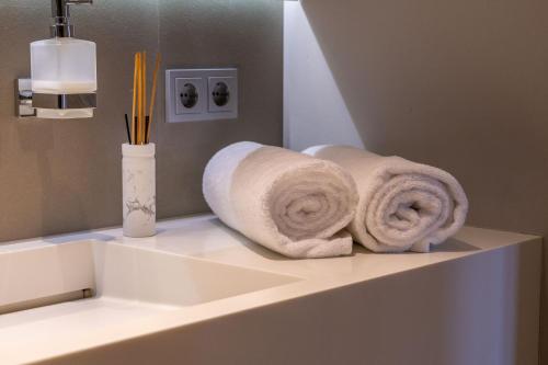 a roll of towels sitting on a counter in a bathroom at Core Luxembourg City- Luxury Brands Street in Luxembourg