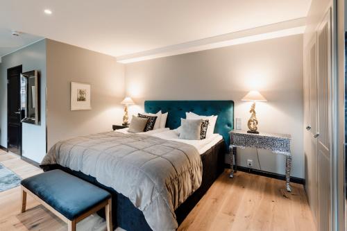 a bedroom with a large bed with a blue headboard at Hotel F6 in Helsinki