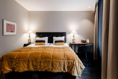 a bedroom with a large bed and a desk at Hotel F6 in Helsinki