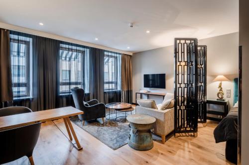 a living room with a couch and a table at Hotel F6 in Helsinki