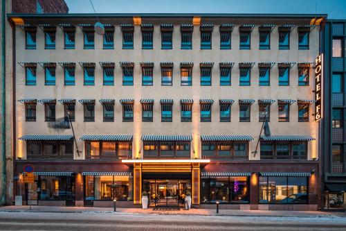 a large building on the corner of a street at Hotel F6 in Helsinki