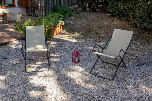 two chairs and a fire hydrant in a yard at Apartment in nature,10min from city in Perugia