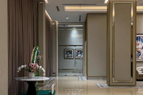 vestíbulo con mesa y ascensor en RedLiving Apartemen Transpark Cibubur - Ens Room, en Depok