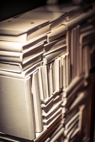 a stack of books stacked on top of each other at Hotel F6 in Helsinki