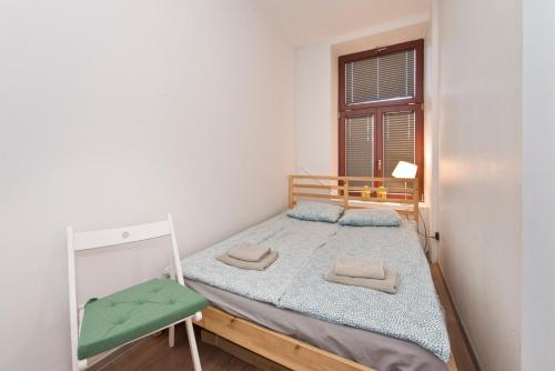 a small bedroom with a bed and a window at Kawalerka Studio Stare Domki in Gdańsk