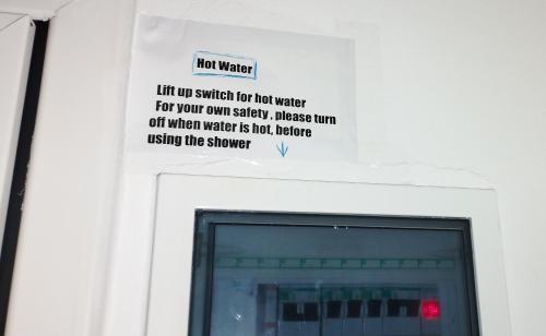 a sign on a wall with a sign above a window at CozyCoast in Rafina