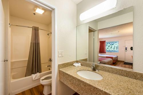 a bathroom with a sink and a toilet and a mirror at Motel 6-Sparks, NV - Airport - Sparks in Reno