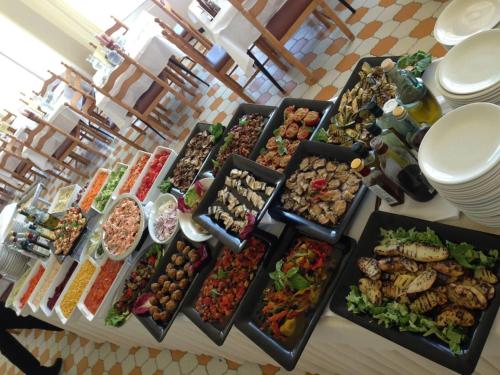 a buffet of different types of food on a table at Hotel Apollonia in Lido di Savio