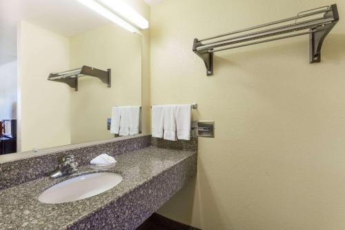a bathroom with a sink and a mirror at Days Inn by Wyndham Fordyce in Fordyce
