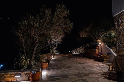 a patio at night with trees and lights at Villa Mavrianos in Kithnos