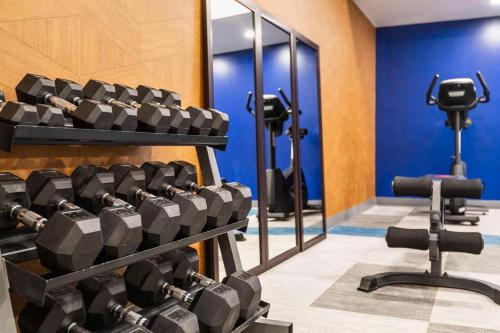 a gym with rows of dumbbells and a mirror at Comfort Inn & Suites Barrie in Barrie