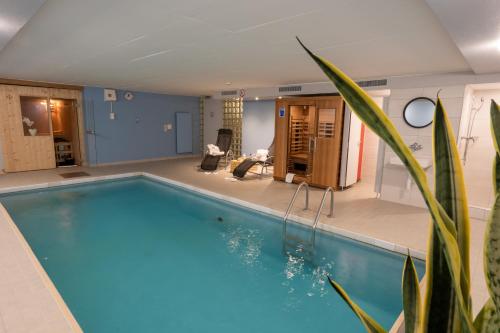 a large swimming pool in a living room at Hotel Sonne in Wildhaus