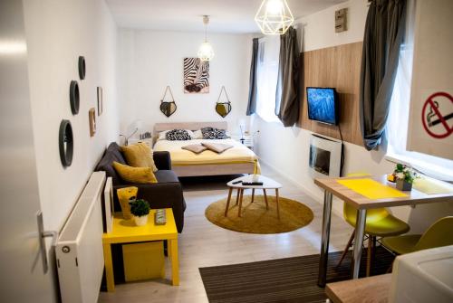 a small living room with a bed and a table at Apartments Lisinski - Private parking in Zagreb