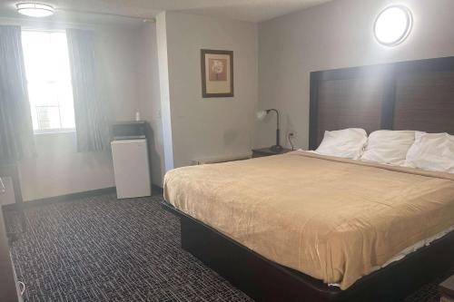 a hotel room with a bed and a window at Days Inn by Wyndham Salisbury, NC in Salisbury