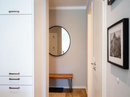 a hallway with a mirror and a wooden table at Strandresidenz Else Marie App 1 4 in Ahlbeck
