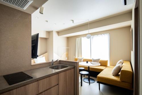 a room with a kitchen and a living room at Section L Yushima-Ueno in Tokyo