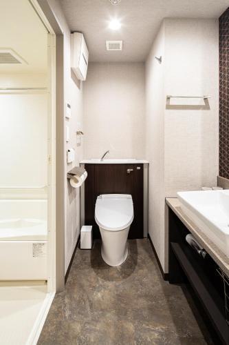 a bathroom with a toilet and a sink at Section L Yushima-Ueno in Tokyo