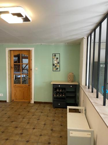 an empty room with a counter and a door at La bergerie in La Bruyère