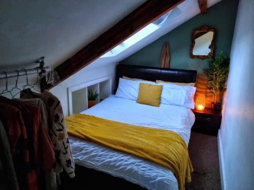 a bedroom with a bed with a yellow blanket at Safire home in Murton