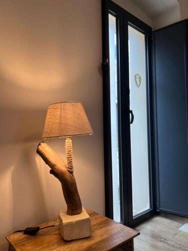 a lamp on top of a table with a hand holding a lamp at Le Dimore Del Gufo - Royal Suite in Venosa