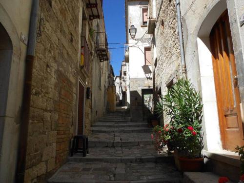 an alley with stone buildings and plants in an alley at da nonna Ida in Civita Campomarano