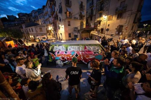 a crowd of people standing around a van in a street at da nonna Ida in Civita Campomarano