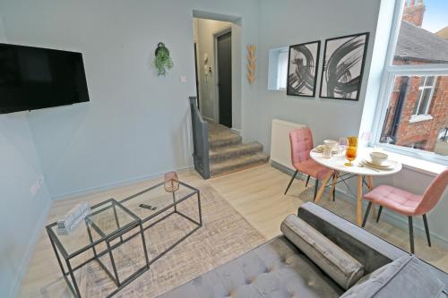 a living room with a couch and a table at Black Pearl Stays - Saltburn Apartments in Saltburn-by-the-Sea