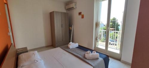 a bedroom with a bed with two white boxes on it at Appartamento Vista Mare aA Briatico 15 Km Da Tropea Calabria in Briatico