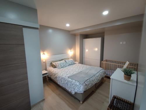 a small bedroom with a bed and a night stand at Casa da Eirinha - Azibo in Macedo de Cavaleiros